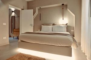 a bedroom with a large white bed with a headboard at Palermo Inn Boutique Arte in Palermo