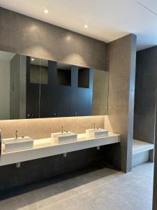 a bathroom with two sinks and a large mirror at 168 KL Selayang Cottage Homestay in Batu Caves