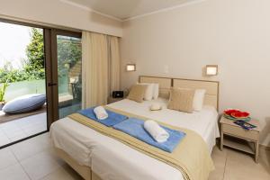 A bed or beds in a room at Trefon Hotel Apartments and Family Suites