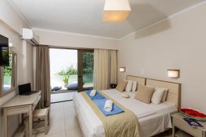 A bed or beds in a room at Trefon Hotel Apartments and Family Suites