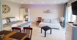 una sala de estar con una cama y un sofá en Balcony Apartman Szeged, en Szeged