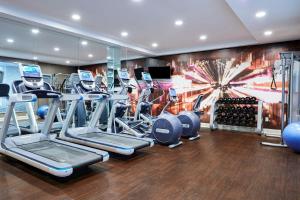 a gym with a bunch of cardio equipment in a room at AC Hotel by Marriott New Orleans French Quarter in New Orleans