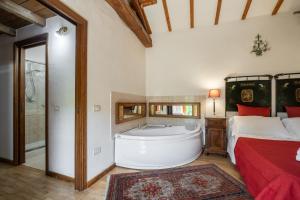 A bed or beds in a room at Corte Cristina & Suites