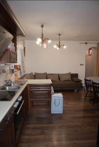 a kitchen and living room with a couch at Tulipános Vendégház in Szőlősardó