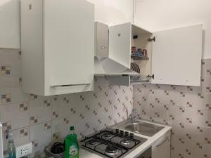 a kitchen with white cabinets and a sink at Ca' Rosso Venice in Venice