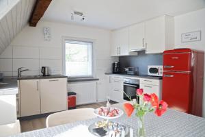 a kitchen with a table and a red refrigerator at Ferienwohnung 3land Reisen in Neuenburg am Rhein