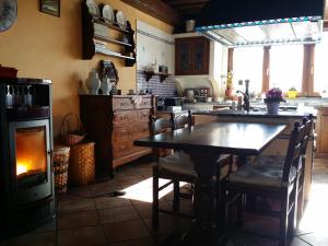 a kitchen with a table and a stove and a fireplace at Peropero' in Gattinara