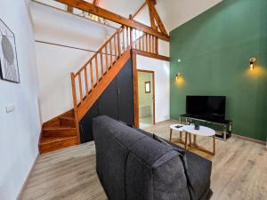 a living room with a couch and a table at Lavoir - Séjour à Auxerre in Auxerre +13 photos