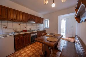 a kitchen with wooden cabinets and a wooden table at La torretta sul cortile in Monteroduni