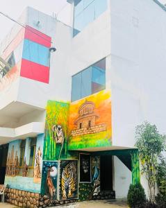 a building with a painting on the side of it at Hotel Tathastu in Rāmtek +13 photos