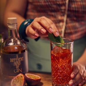 a person is putting a piece of mint into a drink at Banks Mansion - All Inclusive Boutique Hotel in Amsterdam
