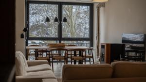 Una sala de estar con una mesa y sillas y una gran ventana. en Sierra Nevada Haven, en Sierra Nevada