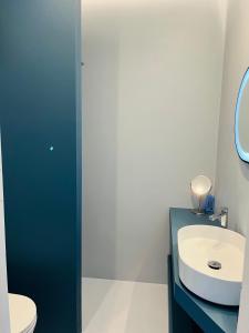a bathroom with a sink and a toilet and a mirror at La Casa Sul Pontile in Vasto