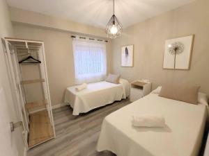 Posteľ alebo postele v izbe v ubytovaní Apartamento Mármoles - Centro Málaga