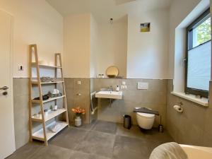 a bathroom with a sink and a toilet at Ferienwohnung Ostseewind 10 Parkvillen Carlota und Candela Baabe in Baabe +27 photos