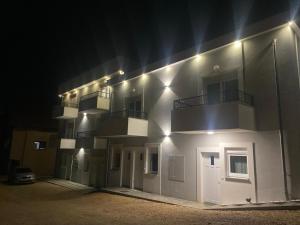 a white building with balconies on it at night at Stan Banja Luka Paprikovac in Banja Luka