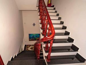 a red spiral staircase in a house at Khách sạn Thảo Lợi in Con Dao