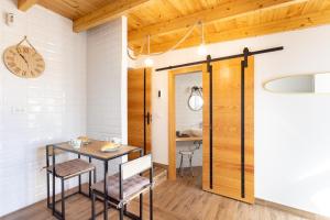 een eetkamer met een tafel, stoelen en een klok bij Home2Book Boutique Cave Retreat, Candelaria in Candelaria