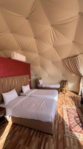 a bedroom with two beds in a tent at Monica Wadi Rum in Wadi Rum