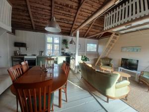 a kitchen and dining room with a table and chairs at Hemma fran Hemma - The Fantasy House in Kvillsfors