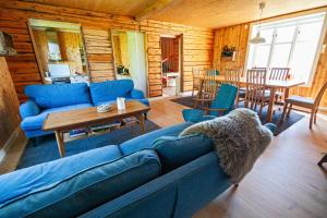 a living room with a blue couch and a table at Solbakken in Ramberg