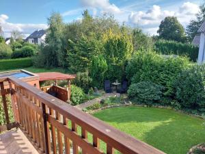 a backyard with a wooden deck and a small garden at Happy Place in Horn-Bad Meinberg
