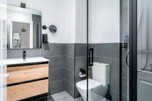a bathroom with a toilet and a sink and a shower at Limehome Malaga Calle Victoria in Málaga