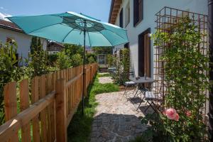 a blue umbrella sitting on a fence with a table at pradl elf my- apartment in Innsbruck
