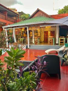 a restaurant with tables and chairs in front of a building at Tupa Hotel Iguazu in Puerto Iguazú