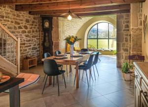 a kitchen and dining room with a table and chairs at Ecogîte de l'adonis in Saint-Beauzile