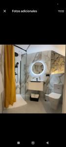 a bathroom with a sink and a toilet and a mirror at Apartamento ideal en calle florista in Valencia