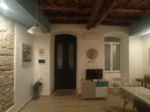 ein Wohnzimmer mit einer schwarzen Tür und einem Fernseher in der Unterkunft PalermHost in Palermo