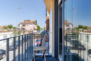 a balcony with a bench and a view of a street at Host Wise - Amadeo Apartments in Vila Nova de Gaia