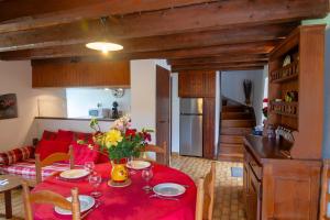 a living room with a table with a red table cloth at Aux cimes des gorges du tarn in Laval-du-Tarn +11 photos