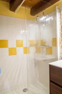 a bathroom with a shower with a glass door at Aux cimes des gorges du tarn in Laval-du-Tarn