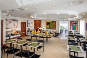 a restaurant with tables and chairs in a room at Best Western Hotel Viterbo in Viterbo