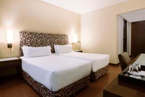 Cama ou camas em um quarto em NH Mendoza Cordillera