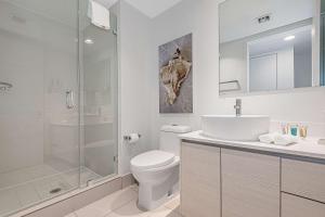 a bathroom with a toilet and a shower and a sink at Lovely Studio with Amazing Views in Hallandale Beach +27 photos