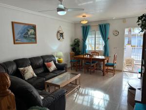 a living room with a couch and a table at Los Flamencos Villa in Los Alcázares