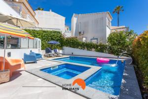a swimming pool in the backyard of a house at #221 Cerro Grande by Home Holidays in Páteo