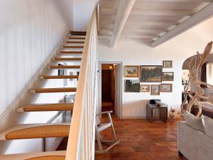 a staircase in a home with white walls and wooden floors at Mas La Bellevue in Murs +139 photos