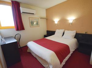 a hotel room with a large bed with a red blanket at Best Hotel Sancé - Mâcon in Mâcon