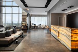 an office lobby with couches and tables and windows at AC Hotel by Marriott Orlando Downtown in Orlando +33 photos