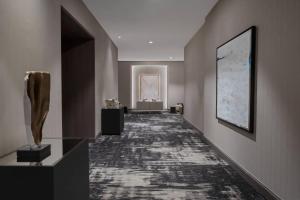 a hallway of a building with a painting on the wall at AC Hotel by Marriott Orlando Downtown in Orlando