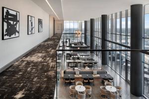 a view of a dining room with tables and chairs at AC Hotel by Marriott Orlando Downtown in Orlando