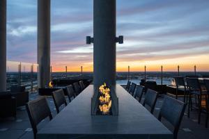 a table with a fireplace on top of a building at AC Hotel by Marriott Orlando Downtown in Orlando