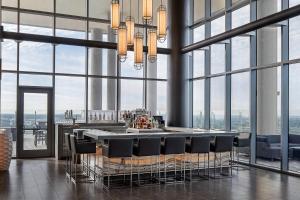 a bar in a building with tall windows at AC Hotel by Marriott Orlando Downtown in Orlando