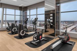 a gym with treadmills and ellipticals in a building at AC Hotel by Marriott Orlando Downtown in Orlando