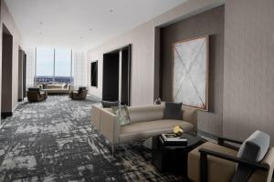 a living room with a couch and a table at AC Hotel by Marriott Orlando Downtown in Orlando