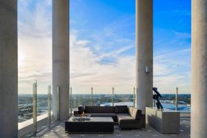 a living room with columns and a couch on a balcony at AC Hotel by Marriott Orlando Downtown in Orlando